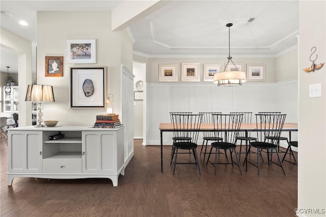 dining room featuring dark wood-type flooring and ornamental molding