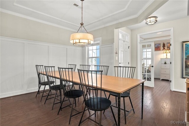 dining room featuring ornamental molding and dark wood-type flooring