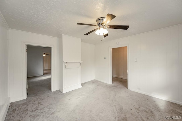 carpeted spare room with ceiling fan and a textured ceiling