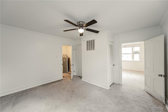 spare room featuring crown molding, light carpet, and ceiling fan