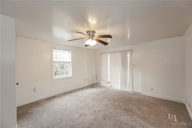 carpeted spare room with ceiling fan