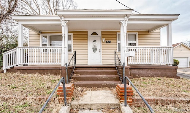 view of front facade with a garage and covered porch