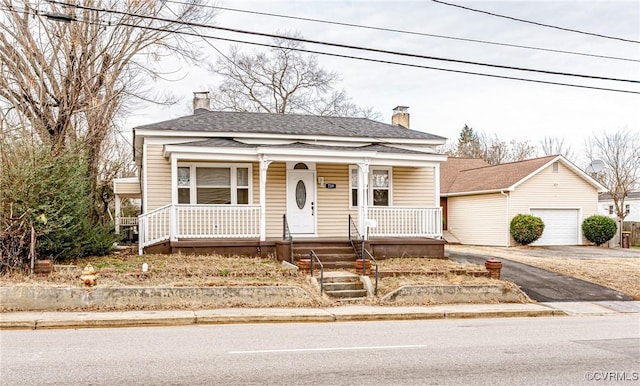 view of front of property with a porch and a garage