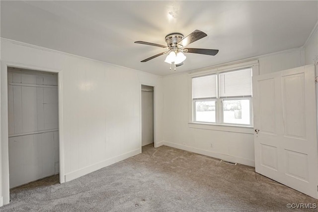 unfurnished bedroom with ornamental molding, light colored carpet, and ceiling fan