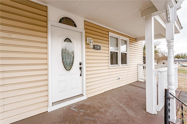 entrance to property featuring covered porch