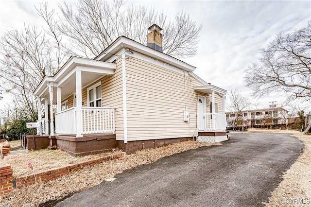 view of side of home with covered porch