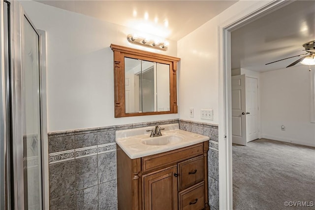 bathroom featuring tile walls, vanity, and ceiling fan