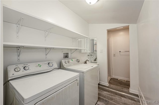 washroom with dark hardwood / wood-style floors and washing machine and clothes dryer