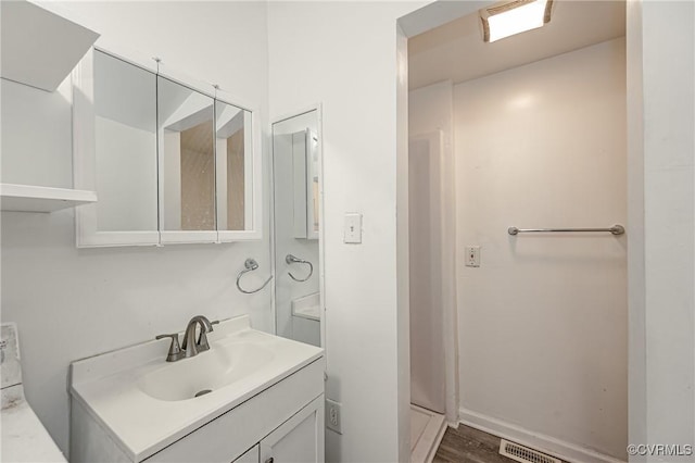 bathroom featuring vanity and hardwood / wood-style floors