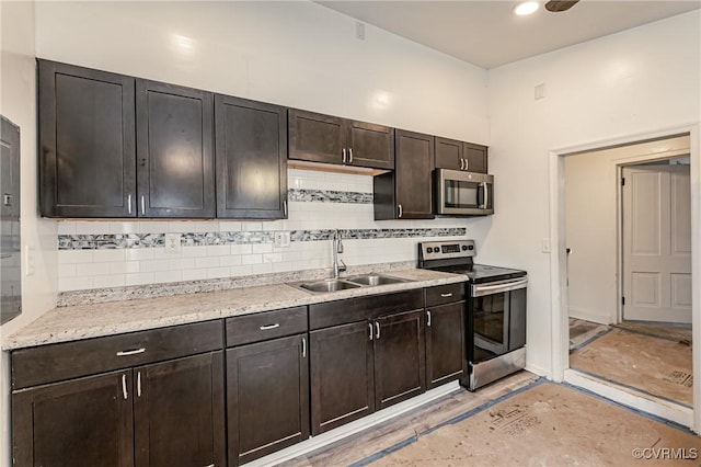 kitchen featuring tasteful backsplash, sink, dark brown cabinets, and appliances with stainless steel finishes