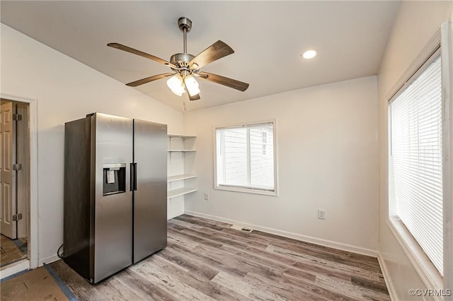 kitchen with lofted ceiling, stainless steel fridge with ice dispenser, hardwood / wood-style floors, and a wealth of natural light