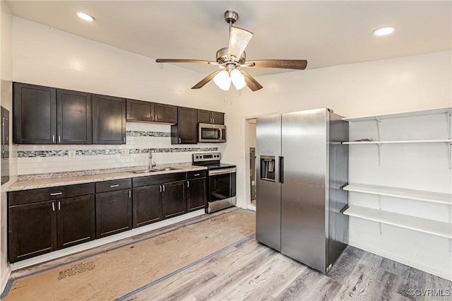 kitchen with sink, light hardwood / wood-style flooring, stainless steel appliances, dark brown cabinetry, and decorative backsplash