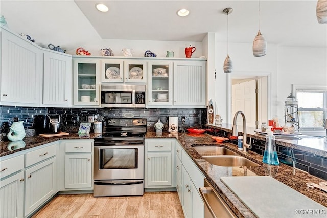 kitchen with white cabinetry, appliances with stainless steel finishes, sink, and pendant lighting