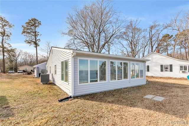 view of property exterior featuring cooling unit and a yard