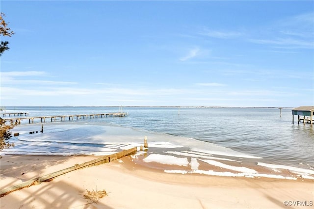 view of dock featuring a water view and a view of the beach