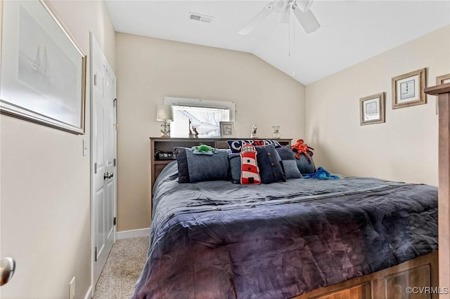 bedroom with ceiling fan, lofted ceiling, and light carpet