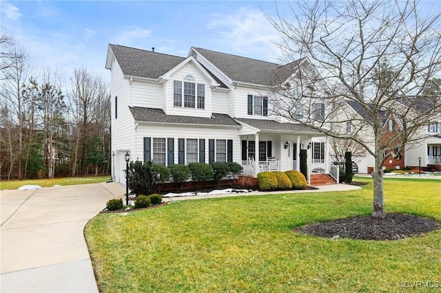 view of front property with a garage, a front lawn, and covered porch