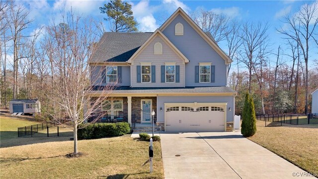 front of property with a garage, a front yard, and covered porch