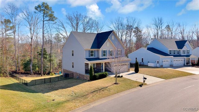 view of front of property with a garage, central AC, and a front lawn