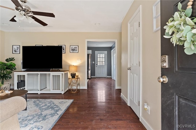 living room featuring dark wood-type flooring and ceiling fan