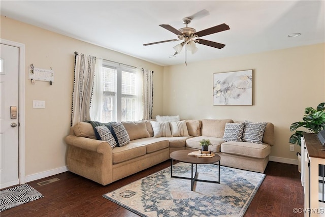 living room featuring ceiling fan and dark hardwood / wood-style flooring