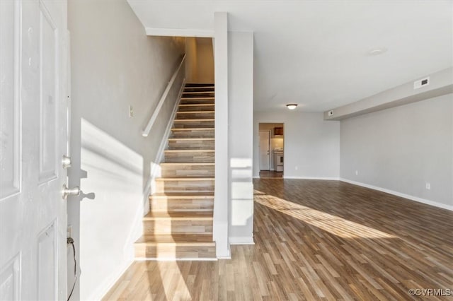 stairway featuring hardwood / wood-style flooring