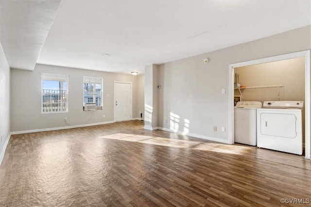 unfurnished living room featuring wood-type flooring and washing machine and clothes dryer