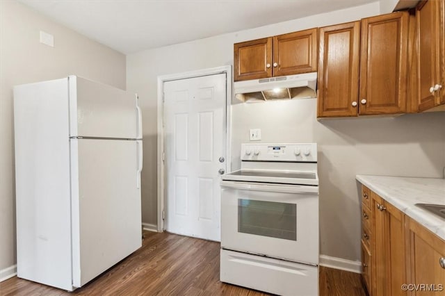 kitchen with white appliances and dark wood-type flooring