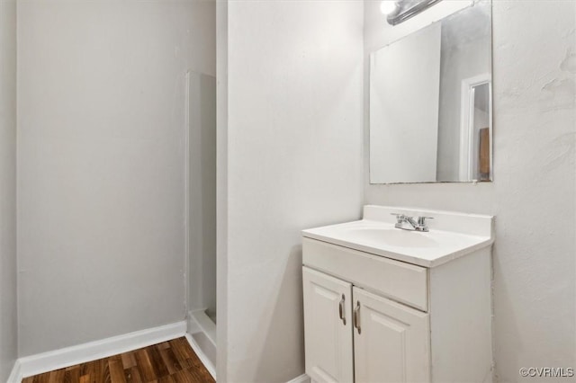 bathroom with vanity, a shower, and wood-type flooring