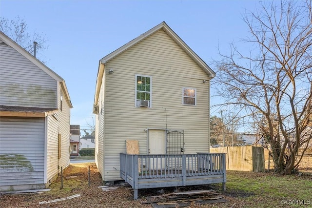 rear view of house featuring cooling unit and a deck