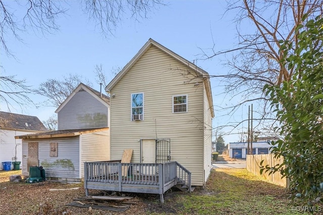 rear view of property featuring a wooden deck