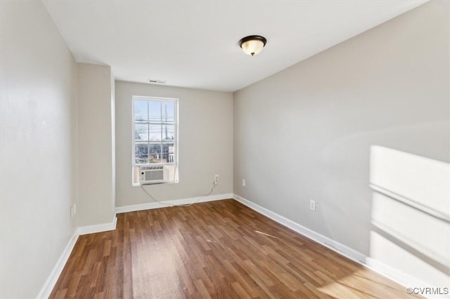 unfurnished room featuring hardwood / wood-style flooring and cooling unit