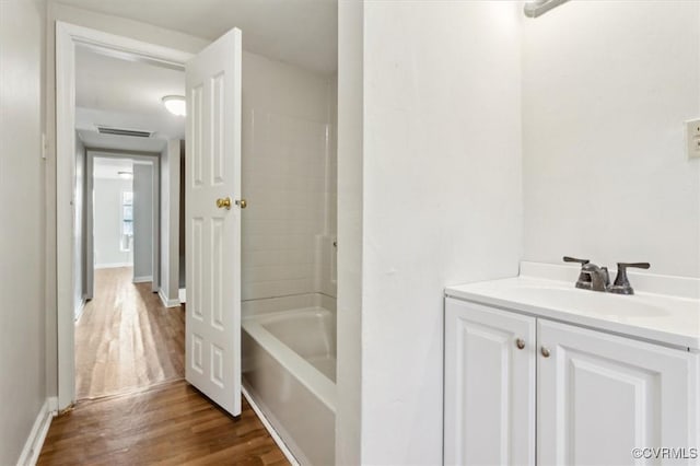 bathroom featuring vanity, hardwood / wood-style floors, and shower / bath combination