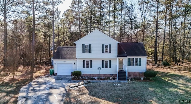 view of property featuring a garage and a front yard