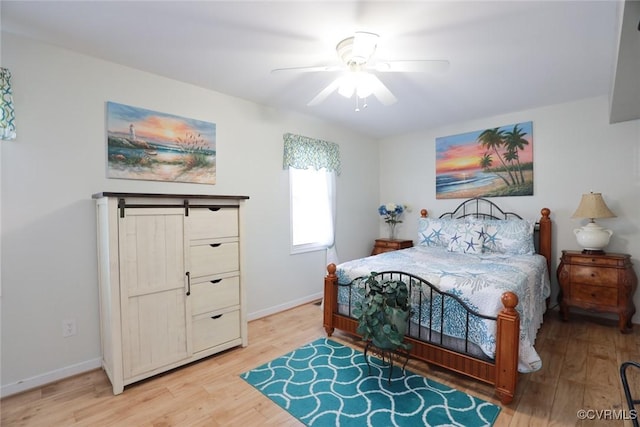 bedroom with ceiling fan and light hardwood / wood-style floors