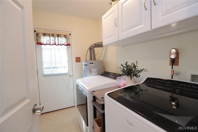 clothes washing area with water heater, washing machine and clothes dryer, and cabinets