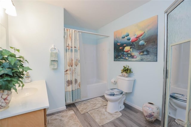 bathroom with vanity, toilet, and hardwood / wood-style floors