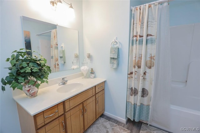 bathroom featuring vanity, shower / bathtub combination with curtain, and wood-type flooring