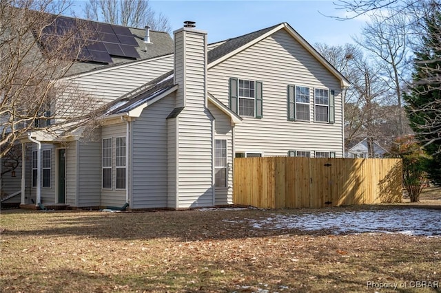 view of side of home with solar panels