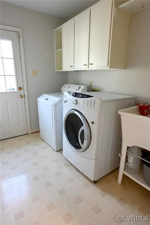 laundry area with cabinets and washing machine and dryer