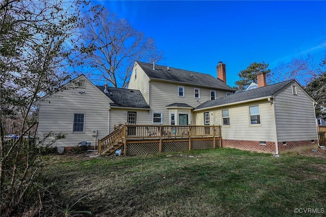 rear view of house with a wooden deck and a lawn