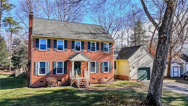 colonial-style house with a garage and a front lawn