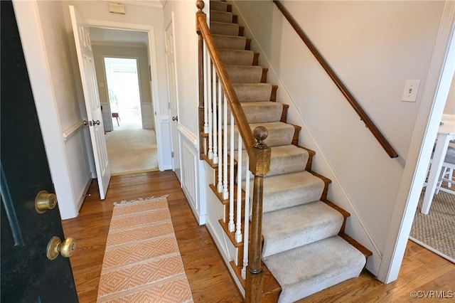 staircase with wood-type flooring