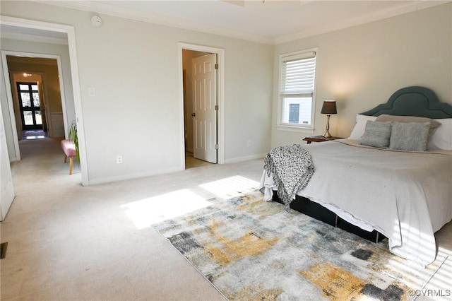 bedroom with crown molding and light carpet