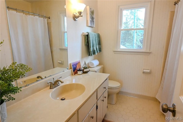 bathroom featuring vanity, toilet, and tile patterned flooring