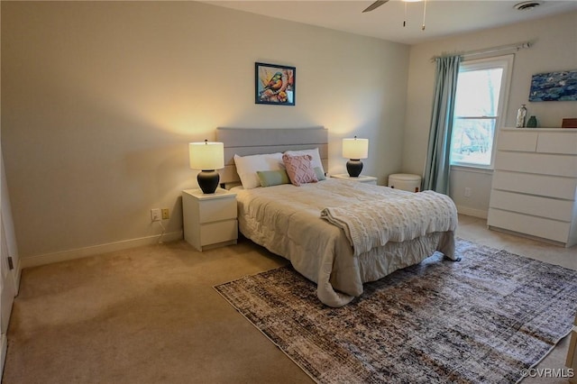 bedroom featuring light colored carpet and ceiling fan