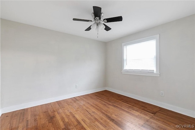 spare room featuring hardwood / wood-style floors and ceiling fan