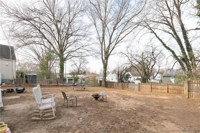 view of yard with an outdoor fire pit