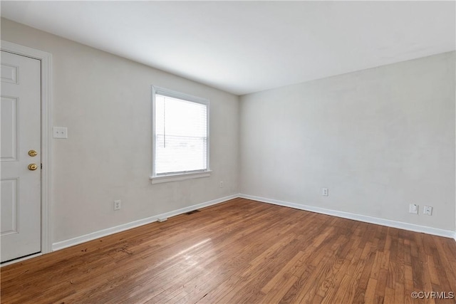 empty room with wood-type flooring