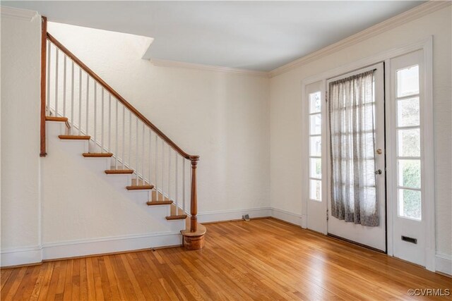 foyer entrance featuring ornamental molding and light hardwood / wood-style floors